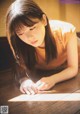 A woman laying on the floor looking at her cell phone.