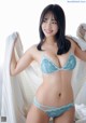 A woman in a blue lingerie posing for a picture.